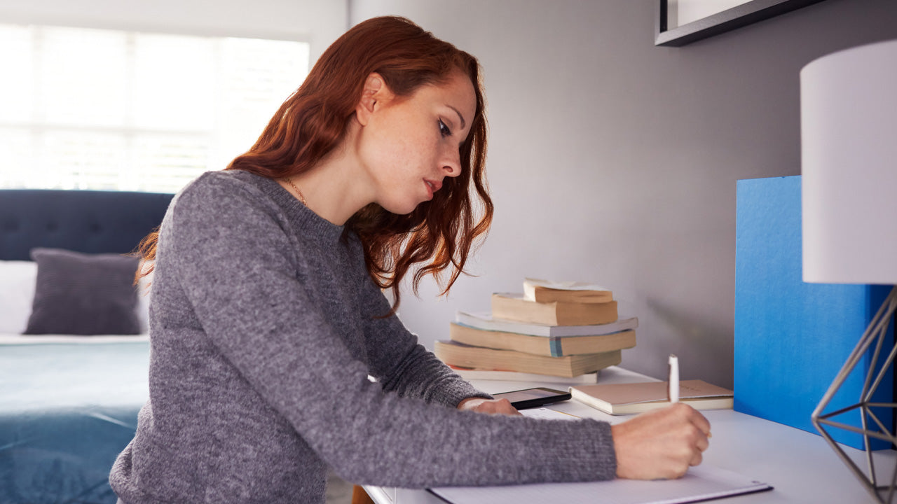 A Girl Writing on a Desk