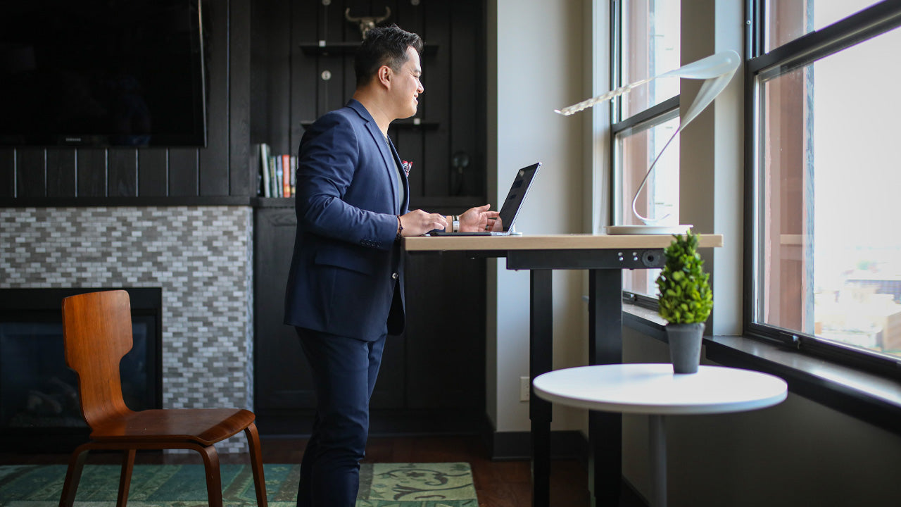 men working on height adjustable standing desk