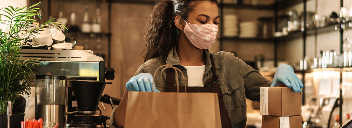 Girl wearing face mask checking the labels on the box